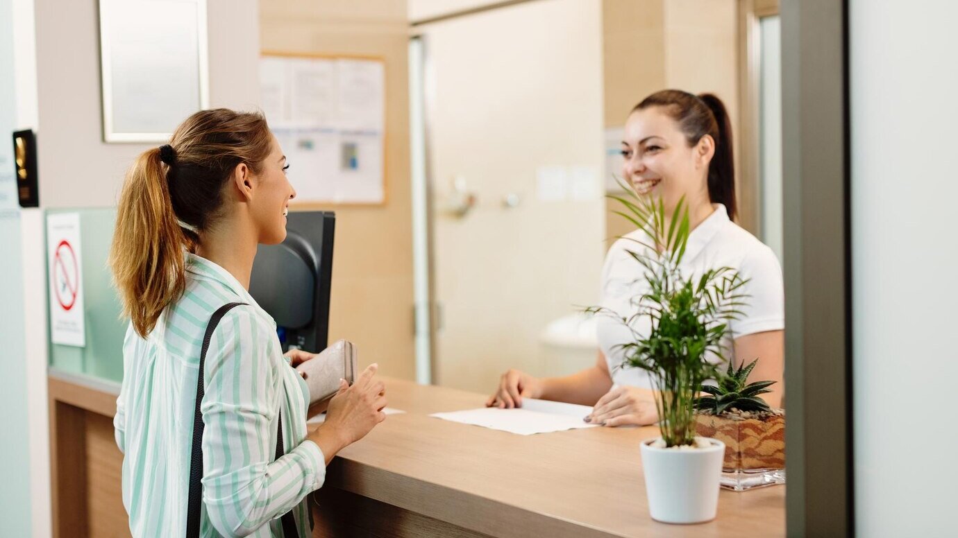 Calm, beautifully designed clinic reception with natural materials and soft lighting